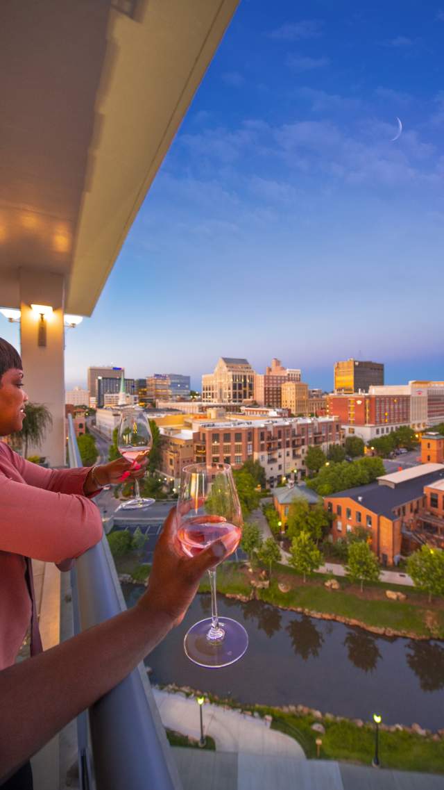 Two ladies enjoy cocktails with great views at UP on the Roof in downtown Greenville, SC.