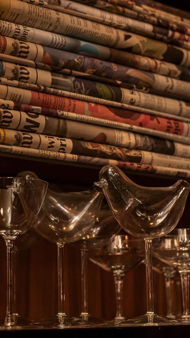Glasses and newspaper are part of the décor at The Press Room speakeasy in downtown Greenville, SC.