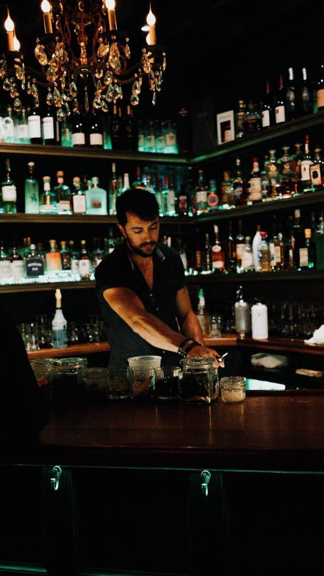 A bartender wipes the counter at The Library at The Rabbit Hole in the Village of West Greenville, SC.