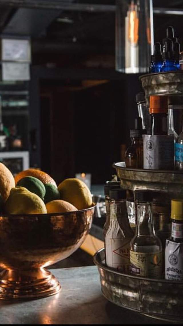 Lemons, limes, oranges, and a range of liquors sit atop a counter at speakeasy Vault & Vator in downtown Greenville, SC.
