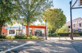Exterior view of Spinx Market & Eatery on a sunny day with several trees nearby