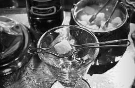 Cocktails with garnishes on an ornate bar top in black and white at Trappe Door