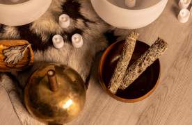 Raven and Moon Sound Bath Experience with sage in a bowl and candles laying around