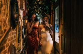 Two girls walk down the hall full of clocks at the Alice in Wonderland-themed Rabbit Hole cocktail bar in downtown Greenville, SC.