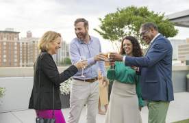 Friends enjoy a drink together at The Avenue, a venue in downtown Greenville, SC.