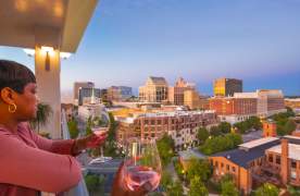 Two ladies enjoy cocktails with great views at UP on the Roof in downtown Greenville, SC.