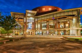 The exterior of the Peace Center lit up at night in downtown Greenville, SC.
