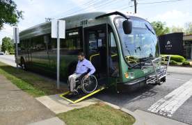 Man in wheelchair getting off Greenlink bus in Greenville, SC