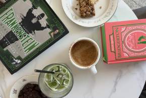 A table with pastries and coffee & matcha from Camilla Kitchen and books from M. Judson Booksellers.
