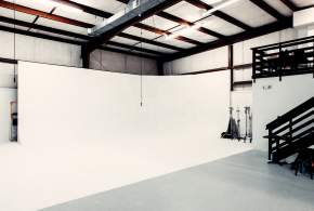 White studio space with bright overhead lights at Kings Collective