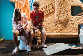 Friends playing mini golf at the Group Therapy Pub & Playground