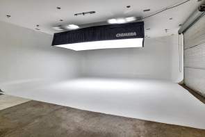 Large white open studio with bright overhead lights diffused to make them less harsh at FishEye Studios