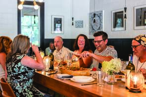 Group of people dining at Topsoil Restaurant.