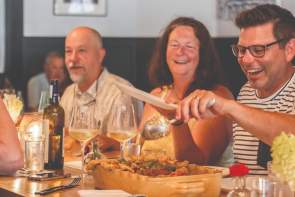 Group of people dining at Topsoil Restaurant.