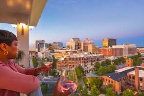 Two ladies enjoy cocktails with great views at UP on the Roof in downtown Greenville, SC.
