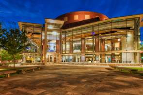 The exterior of the Peace Center lit up at night in downtown Greenville, SC.