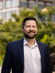 Ray Reulbach headshot at Riverplace on a sunny summer day