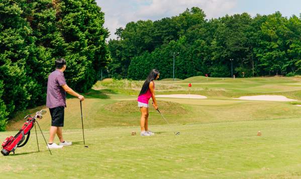 Two golfers at 3's Greenville Golf in Greenville, SC.