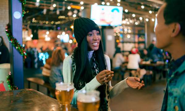 People enjoy the sights, sounds, tastes, and aromas at a downtown brewery with friends.