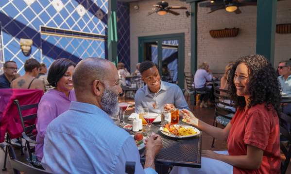 Family dining outdoors at Pomegranate Restaurant