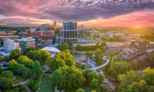 The sun shines in beautiful pink and purple hues above downtown Greenville, SC.