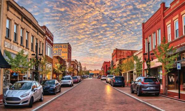 Trade Street in downtown Greer, SC looks idyllic with strung lights and old-timey shops and buildings.