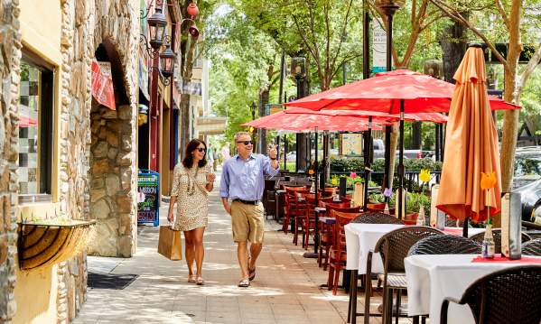 Couple walking past outdoor dining on Main Street