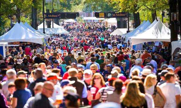 Large gathering of vendors and customers on the streets of Greenville during the Fall for Greenville event.