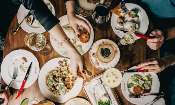 Scoundrel Restaurant food spread with people dining