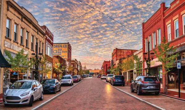Trade Street in downtown Greer, SC looks idyllic with strung lights and old-timey shops and buildings.