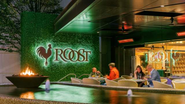 Exterior of Roost with several diners eating.