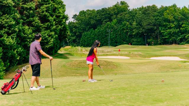 Two golfers at 3's Greenville Golf in Greenville, SC.