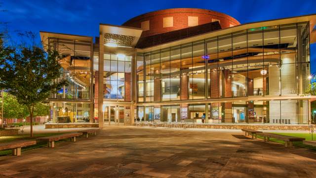 The exterior of the Peace Center lit up at night in downtown Greenville, SC.