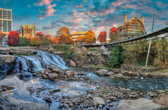 Reedy River Falls and Liberty Bridge right before sunset; construction of Grand Bohemian Lodge Greenville also visible