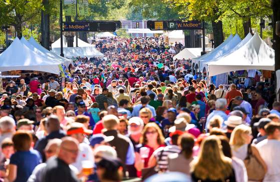 Large gathering of vendors and customers on the streets of Greenville during the Fall for Greenville event.