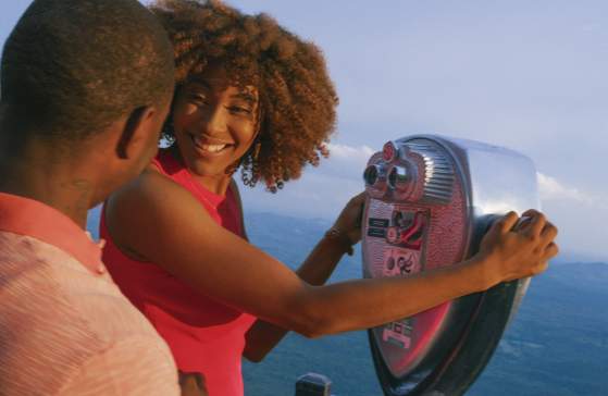People looking through a tower viewer at Caesar's Head