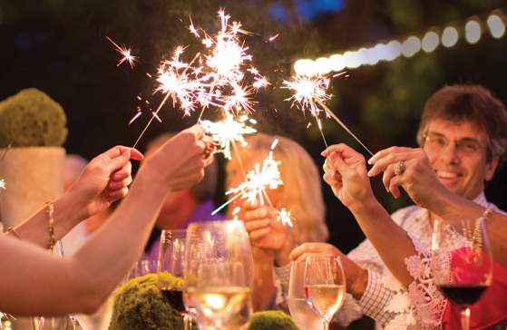 People holding sparklers while attending a party at a Cliffs Community.