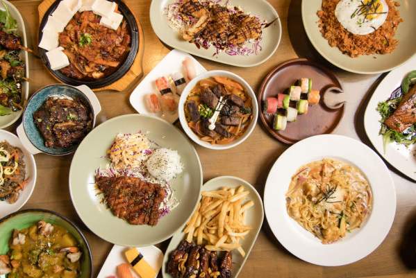 Table full of food and dishes prepared at Otto Izakaya Downtown