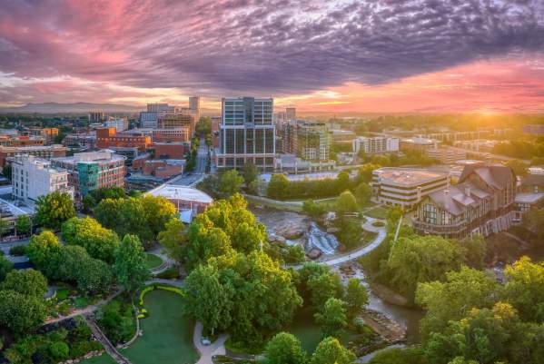 The sun shines in beautiful pink and purple hues above downtown Greenville, SC.
