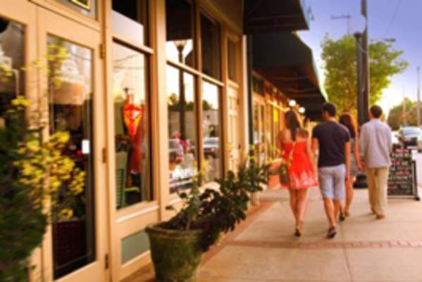 People walking down a street window shopping