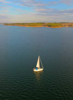 A lone sailboat sits amid the vast Lake Hartwell in South Carolina.