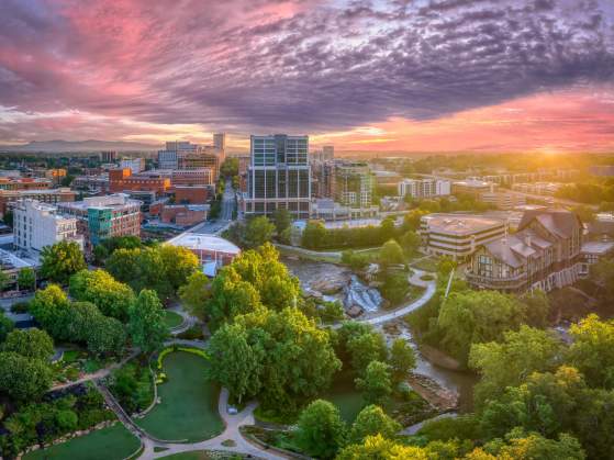 The sun shines in beautiful pink and purple hues above downtown Greenville, SC.