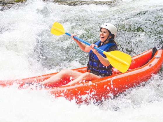 Lady Kayaking in rough waters