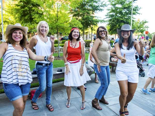 A group of ladies having a fun time dancing in the streets!
