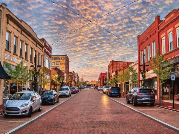 Trade Street in downtown Greer, SC looks idyllic with strung lights and old-timey shops and buildings.
