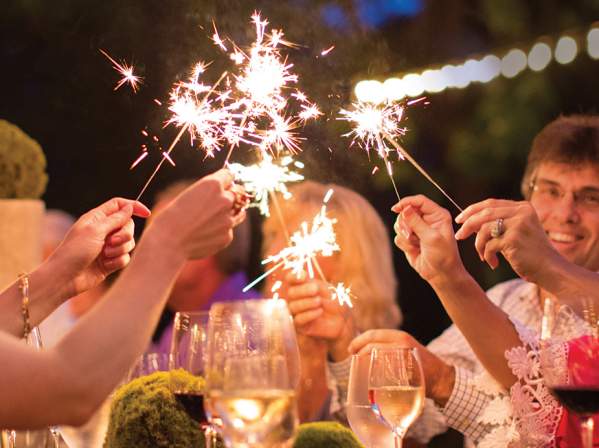 People holding sparklers while attending a party at a Cliffs Community.