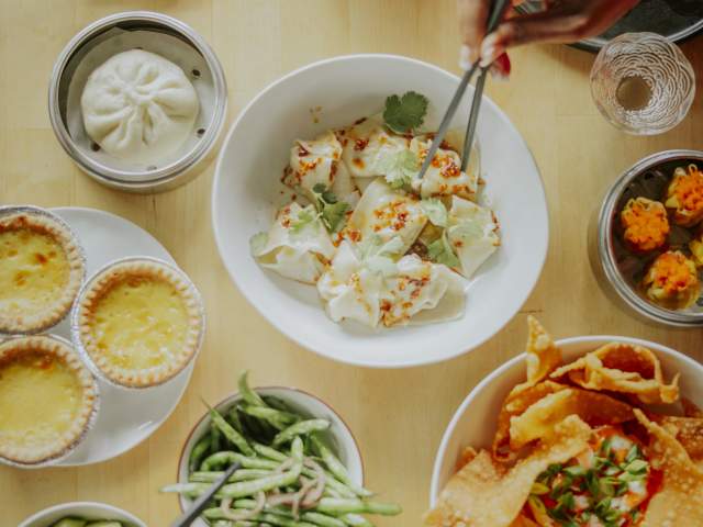 Multiple plates of food at Sum Bar