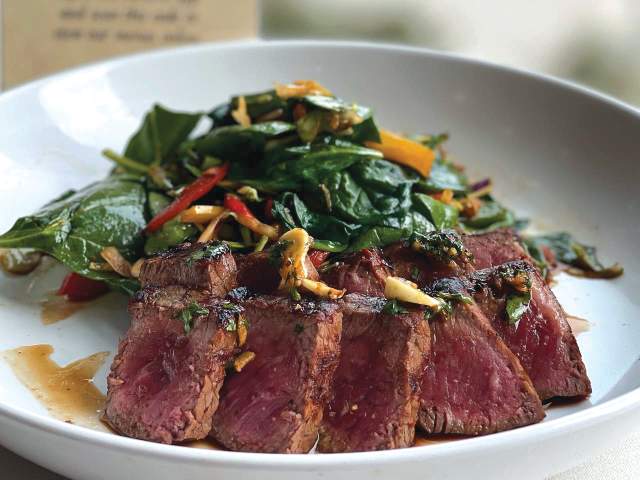 Cooked to perfection, mouthwatering steak that is beautifully prepared alongside a refreshing salad.