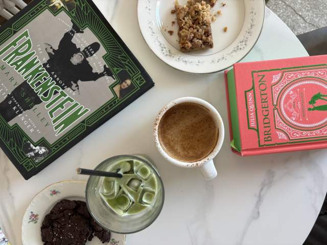 A table with pastries and coffee & matcha from Camilla Kitchen and books from M. Judson Booksellers.