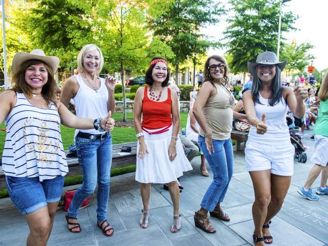 A group of ladies having a fun time dancing in the streets!